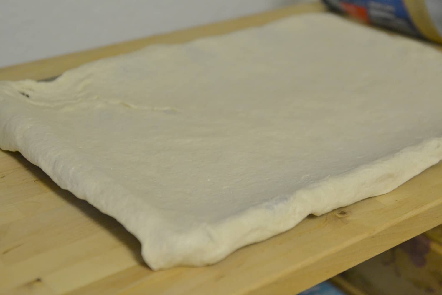 Press dough into parchment-lined cookie sheet, with excess hanging over edge of pan.