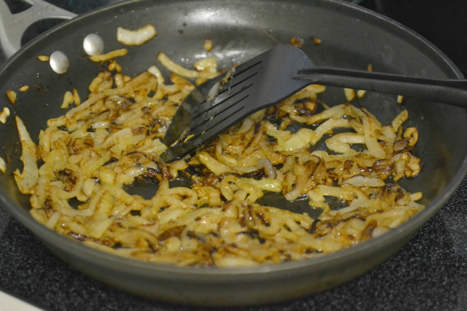 Heat olive oil and butter in a large frying pan over medium high heat and saute onions until golden brown and caramelized.