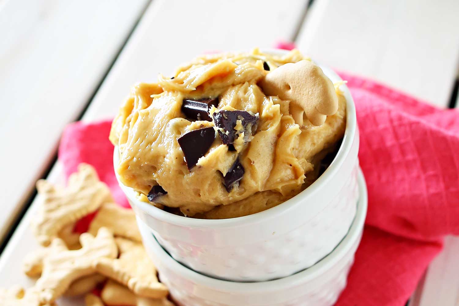 Serve finished chocolate peanut butter dessert dip in small white ceramic bowls. 