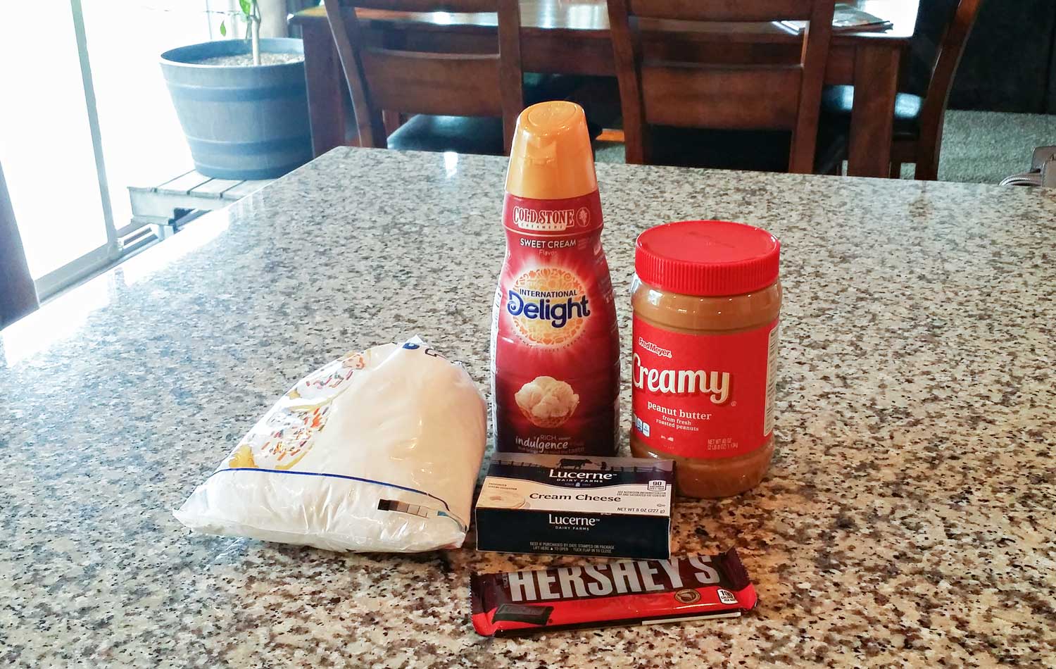  Assemble all your ingredients: peanut butter, cream cheese, confectioners sugar, sweet cream coffee creamer and chopped chocolate pieces. 