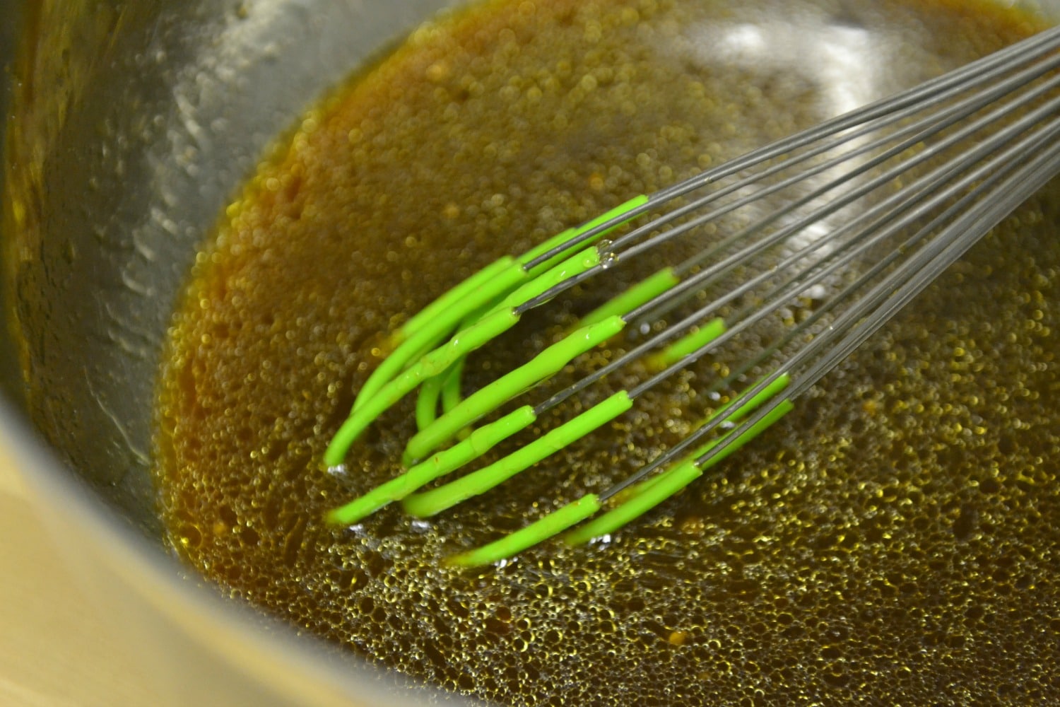 In large bowl whisk together olive oil, chicken broth, soy sauce, minced garlic, honey and Sriracha.