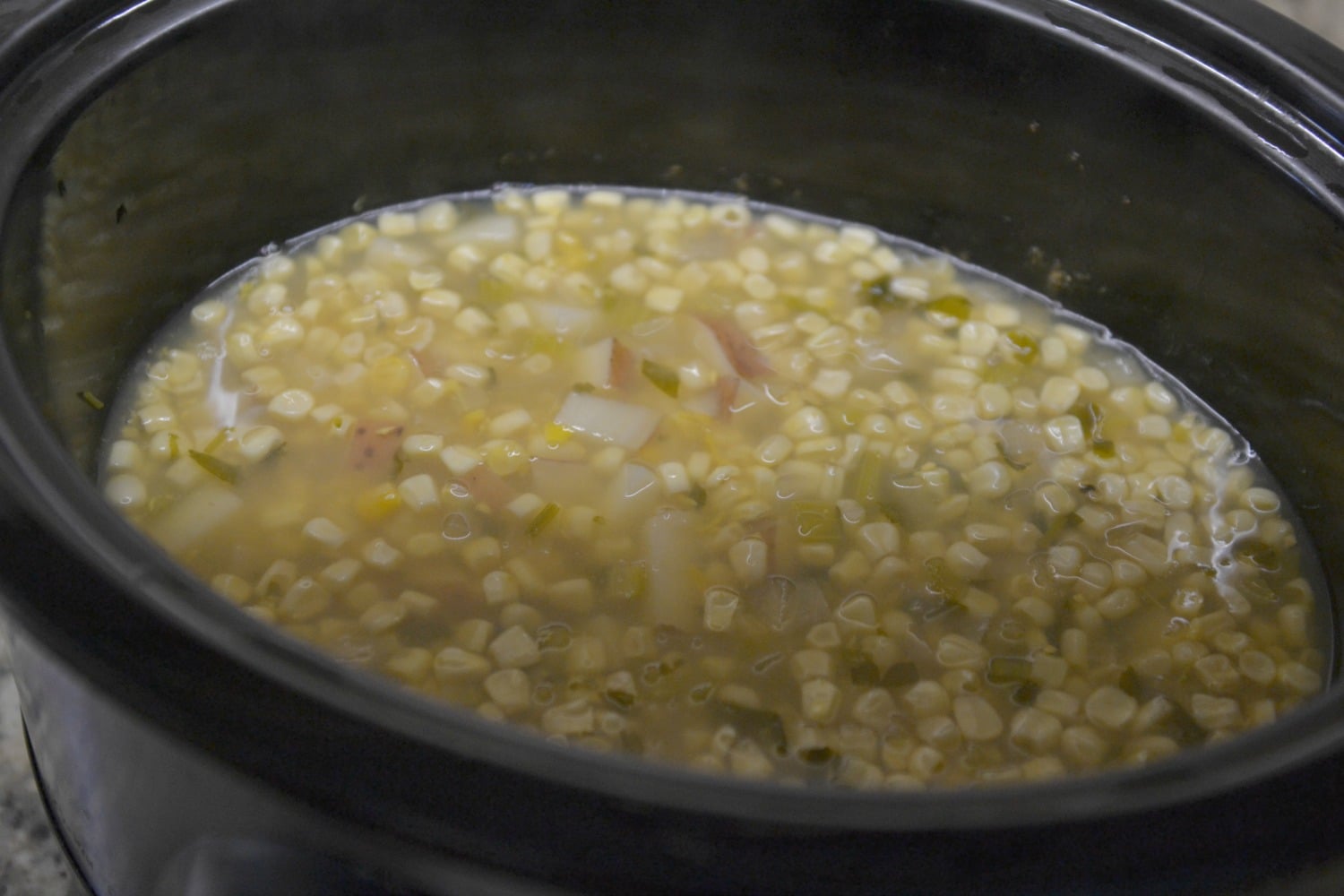 On cooking day, place frozen corn and clam chowder soup directly into slow cooker. 