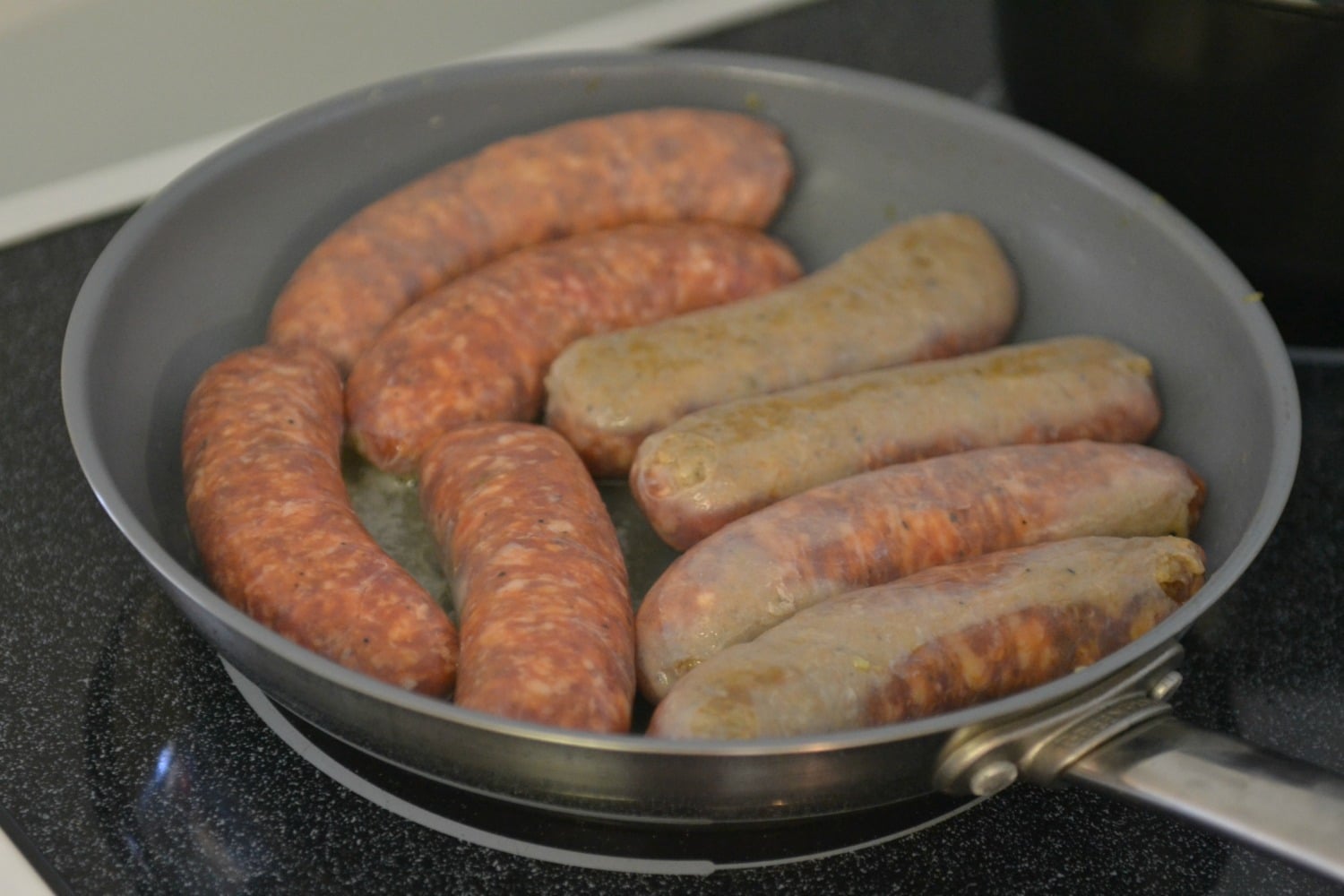 Brown the Italian sausages in a frying pan.