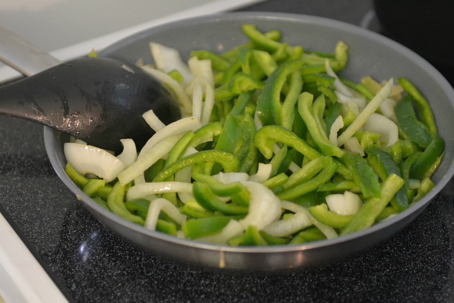 Saute the peppers and onions over medium heat. 