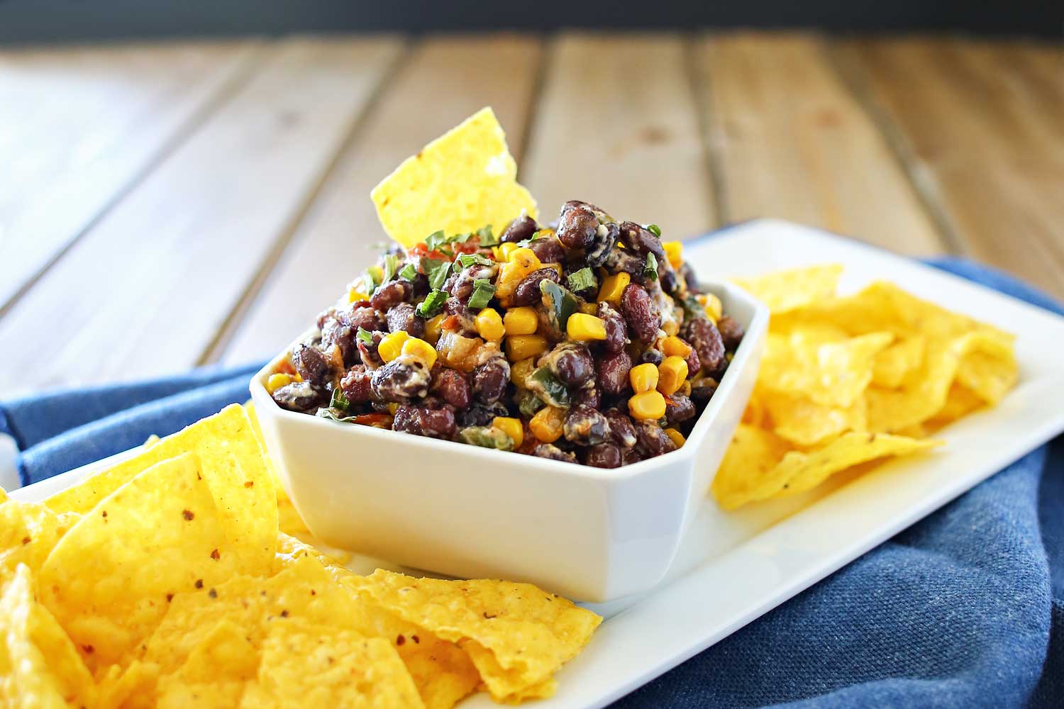 Transfer corn and black bean salsa to serving bowl, garnish with chives and serve with tortilla chips.