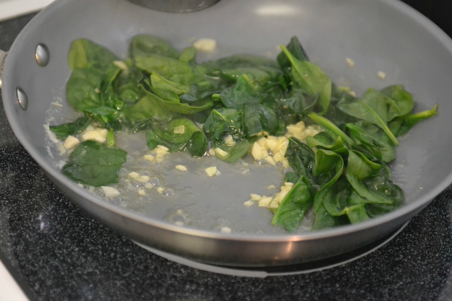 Saute the spinach with garlic and olive oil in a pan. 