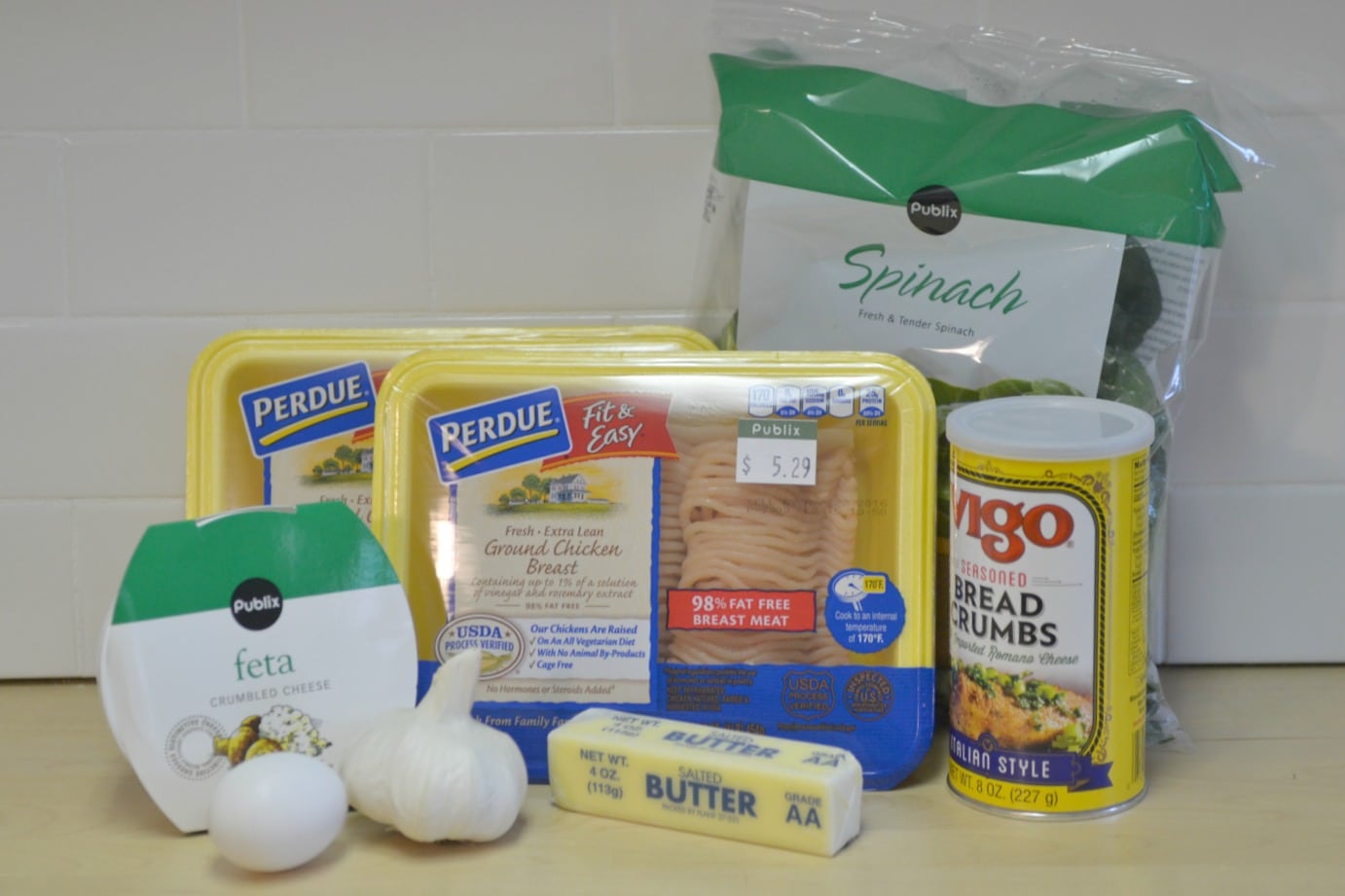 Assemble your ingredients: feta, garlic, egg, butter, breadcrumbs, spinach and ground turkey.