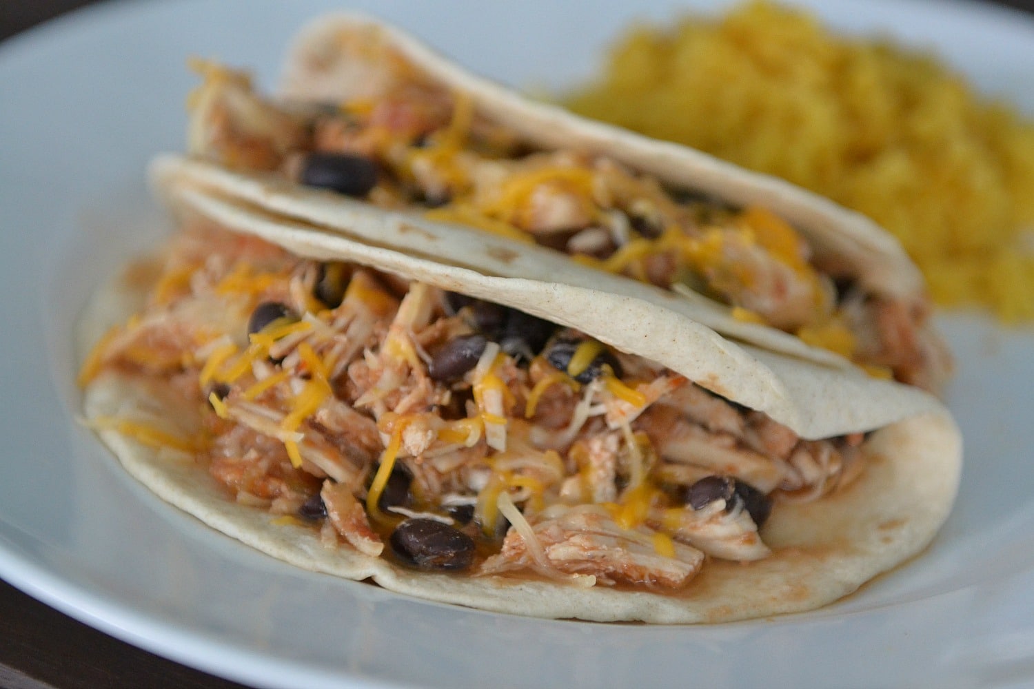 Serve salsa chicken in tortillas topped with shredded cheese. 