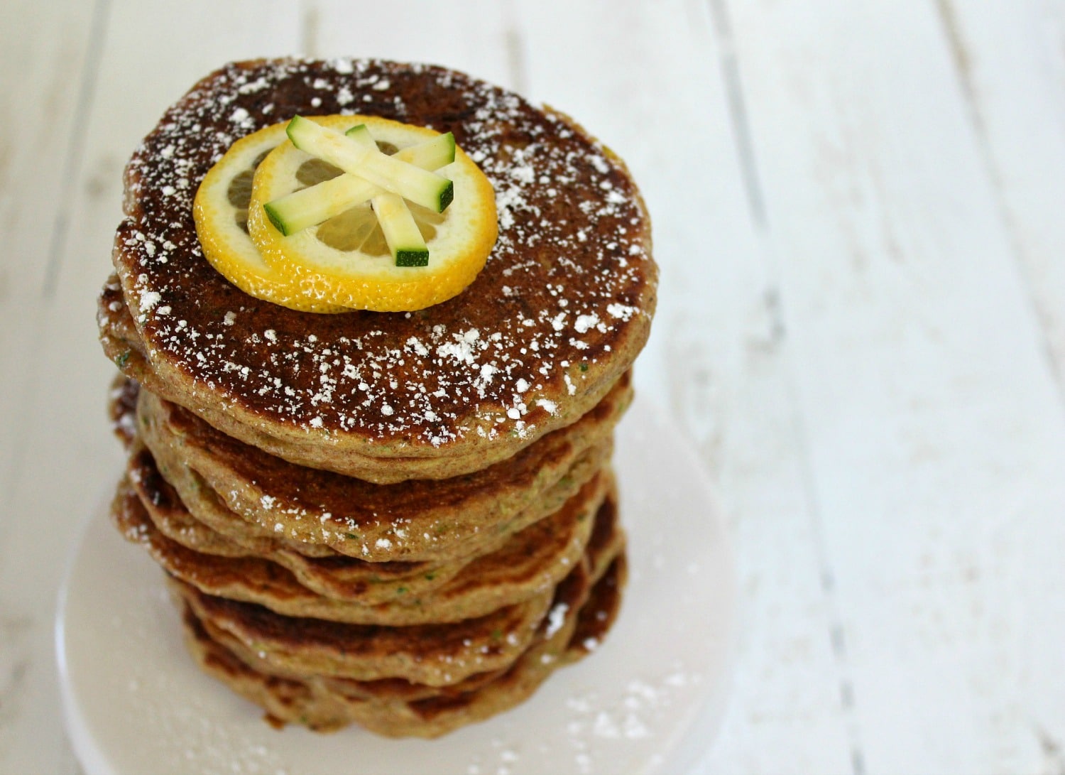 Serve finished lemon zucchini pancakes with powdered sugar. 