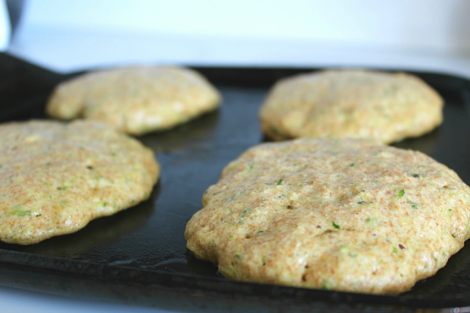 Cook zucchini pancakes on skillet over medium heat. 