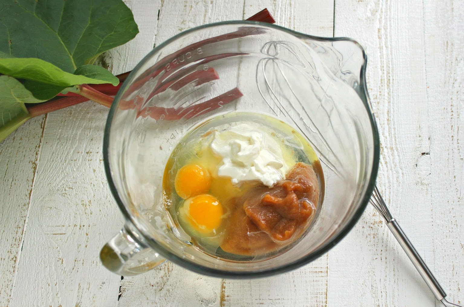 In a large bowl, mix together the wet ingredients, including the eggs, applesauce, sour cream, and melted coconut oil. 