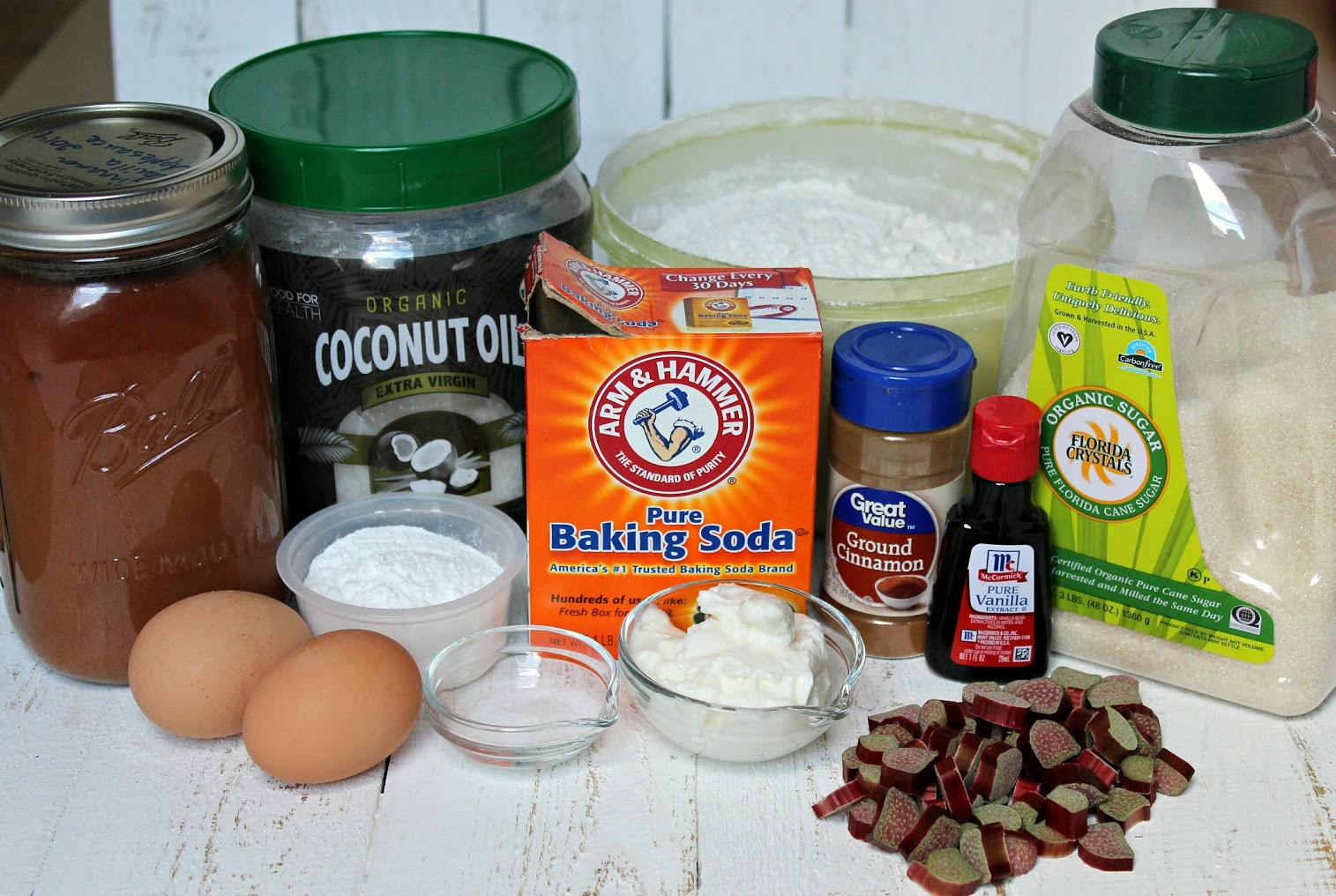 The ingredients needed for Easy Rhubarb Muffins; coconut oil, gluten-free flour, cinnamon, sugar, and rhubarb.