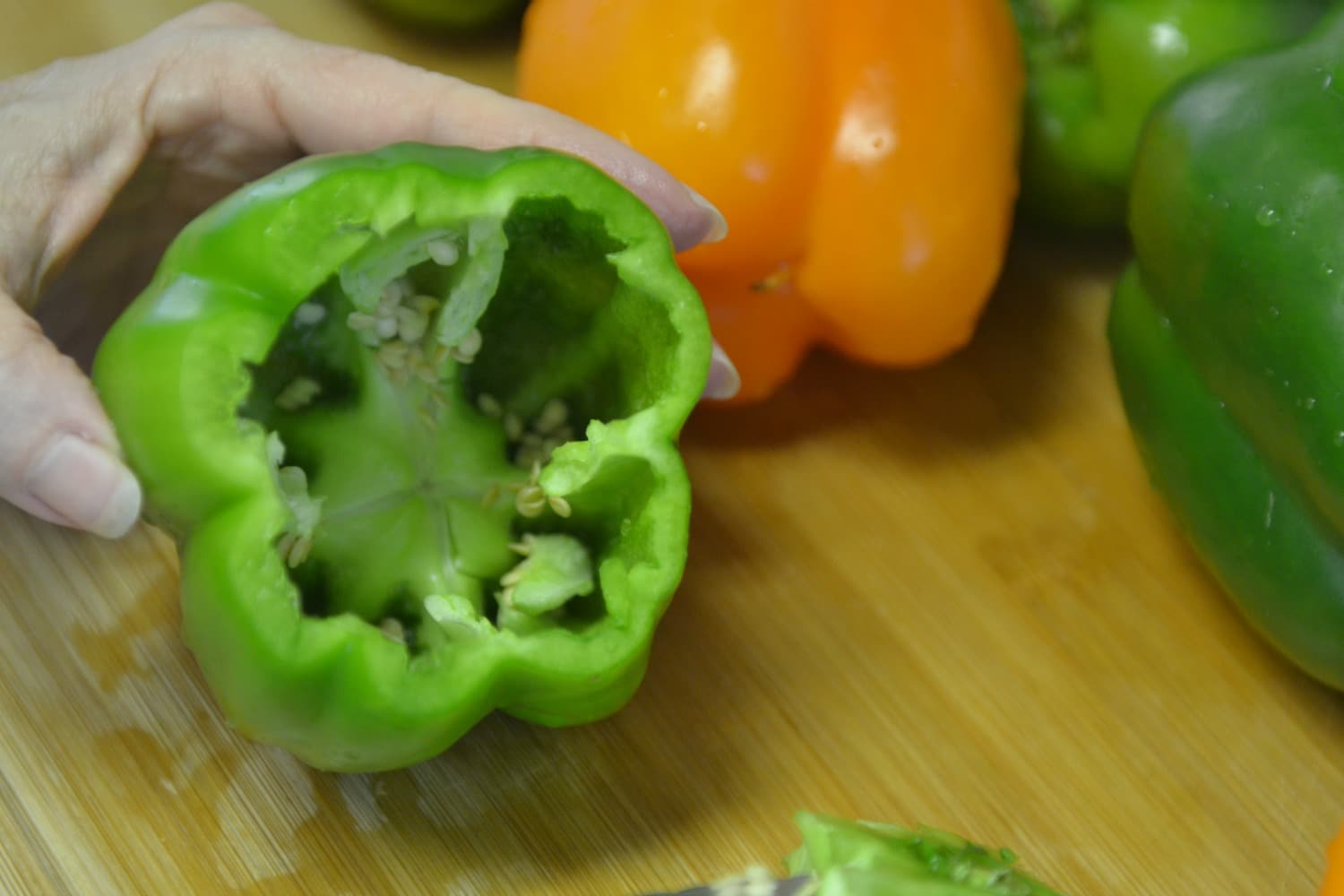 Cut the center stem out of the green bell peppers and remove the seeds. 