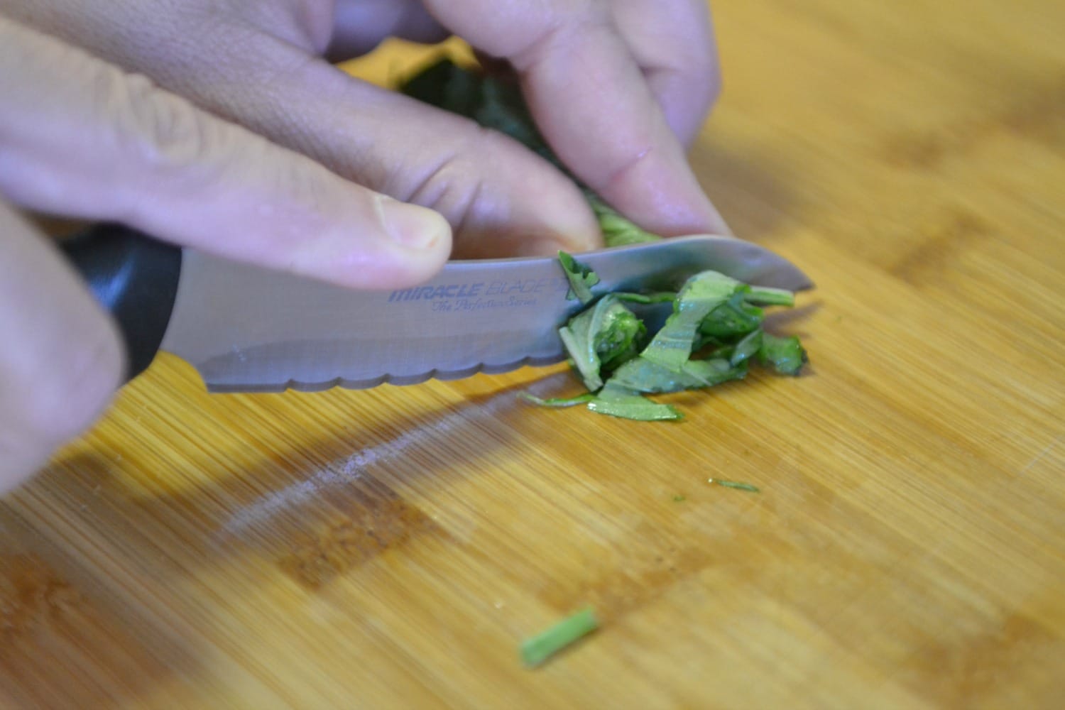 To cut basil, roll the basil leaves and chop. 