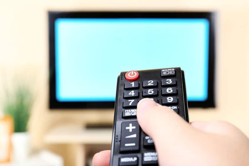 A television remote pointed at a TV screen. 