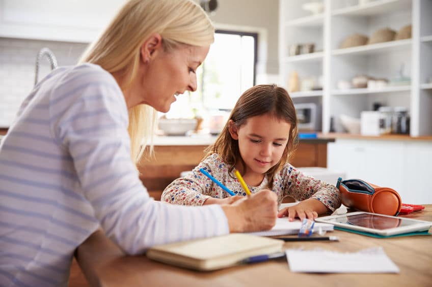 A mother helping her daughter with homework. 