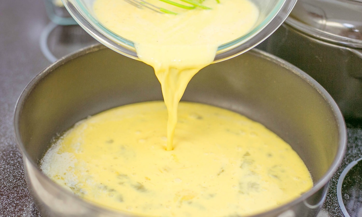 Pour eggs into a pan with melted butter