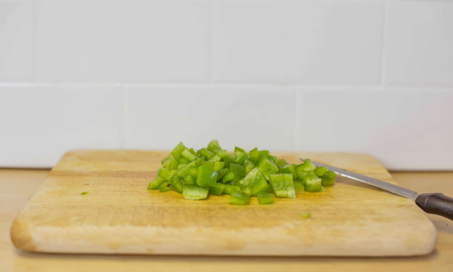 Dice a green pepper into small chunks for this easy chicken jambalaya. 