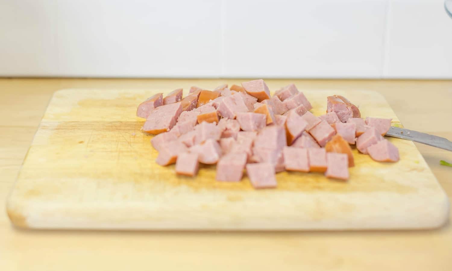 Slice the sausage into small, bite-sized pieces to add flavor to your jambalaya. 