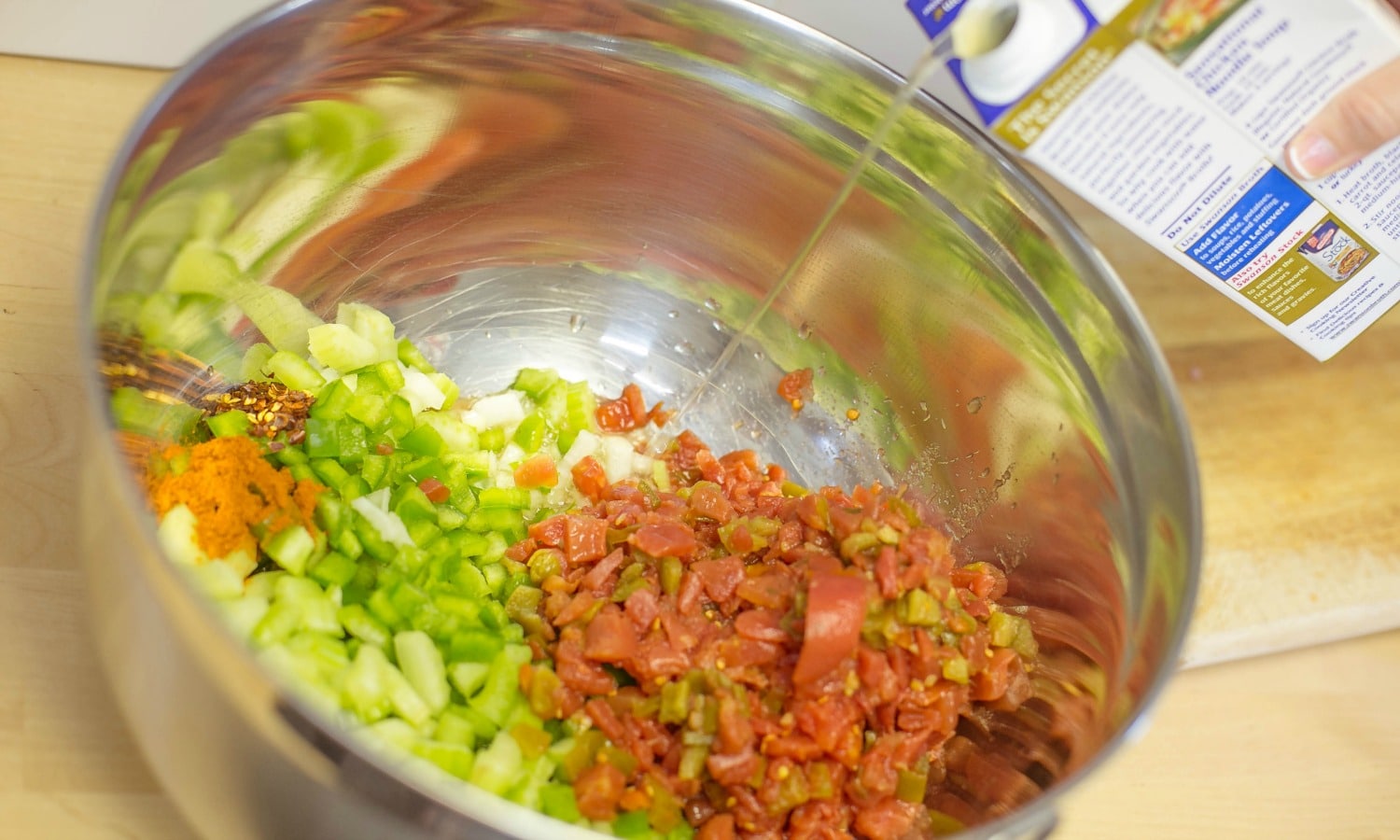 In a large bowl mix the veggies, tomato and chicken stock. 