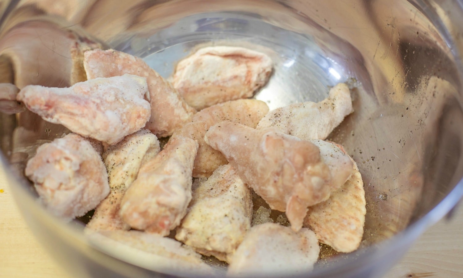 Prepare the chicken wings in a large mixing bowl. 