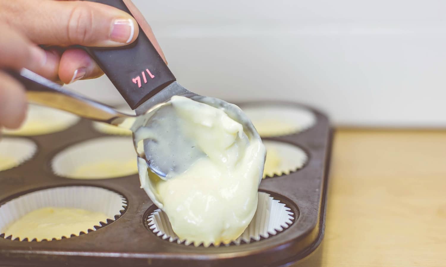 The next step for the easy Mini Cheesecakes is to spoon the creamy filling over the cookies.