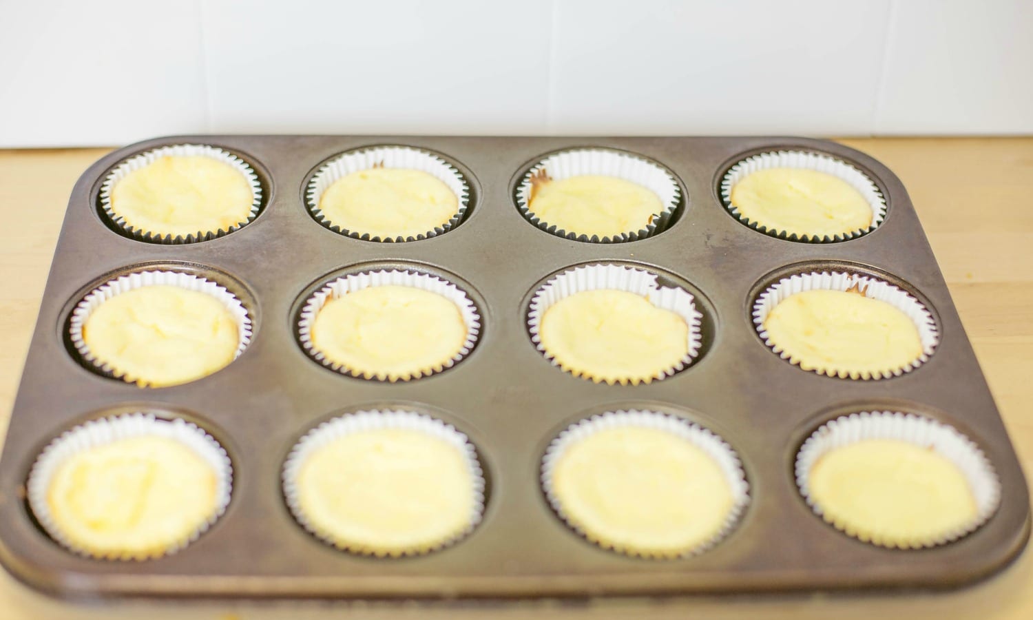 Almost done! Bake for 20 minutes and then cool these amazing-smelling, easy Mini Cheesecakes.