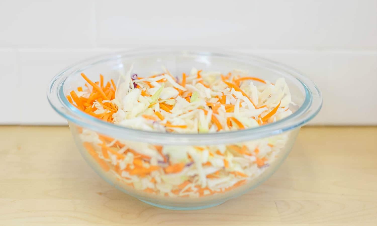 Mix shredded cabbage and carrots for the coleslaw topping