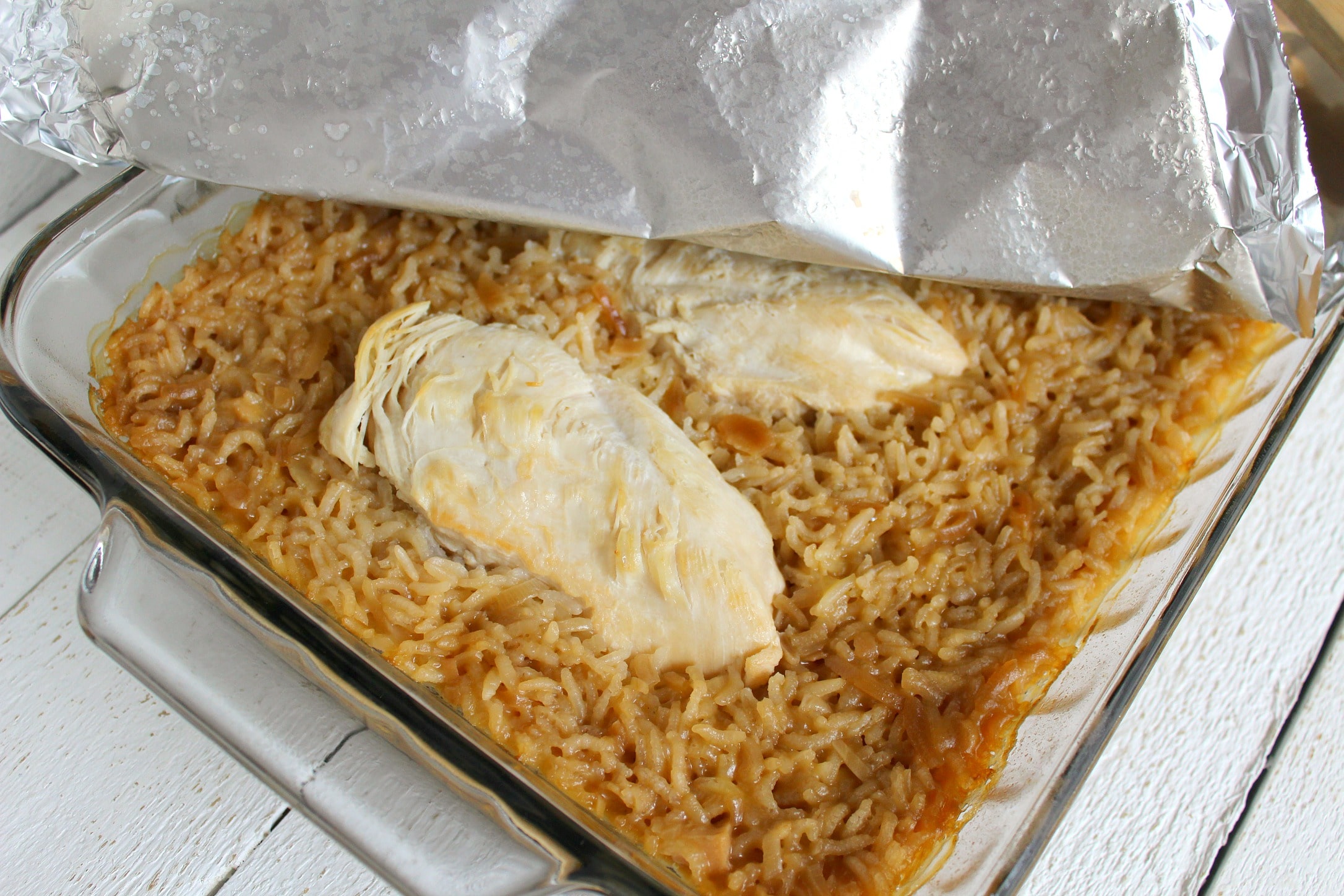 Cover the chicken and rice casserole with foil and bake. 