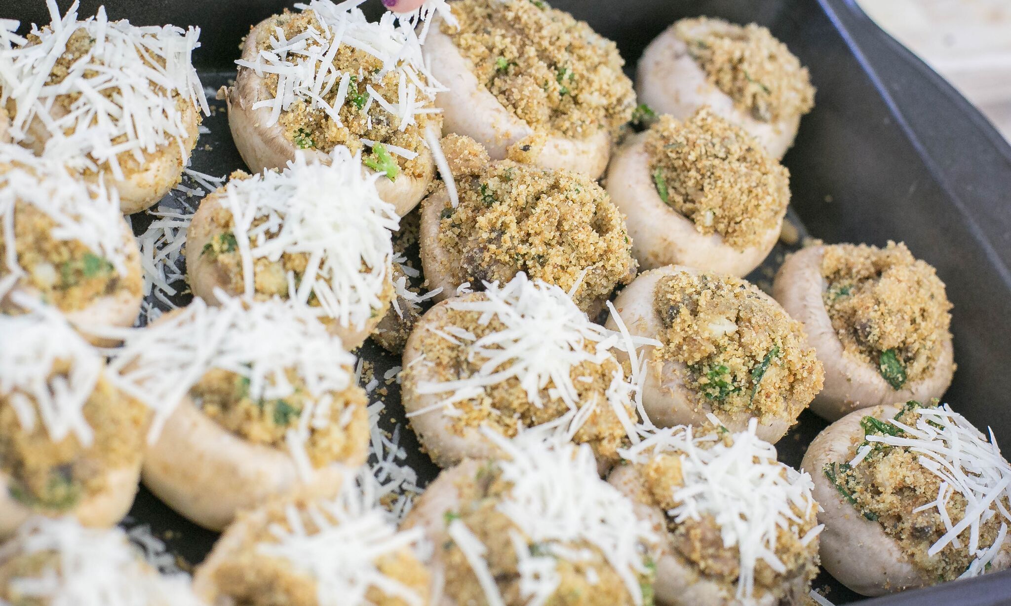 Sprinkle shredded parmesan cheese over stuffed mushrooms before baking. 