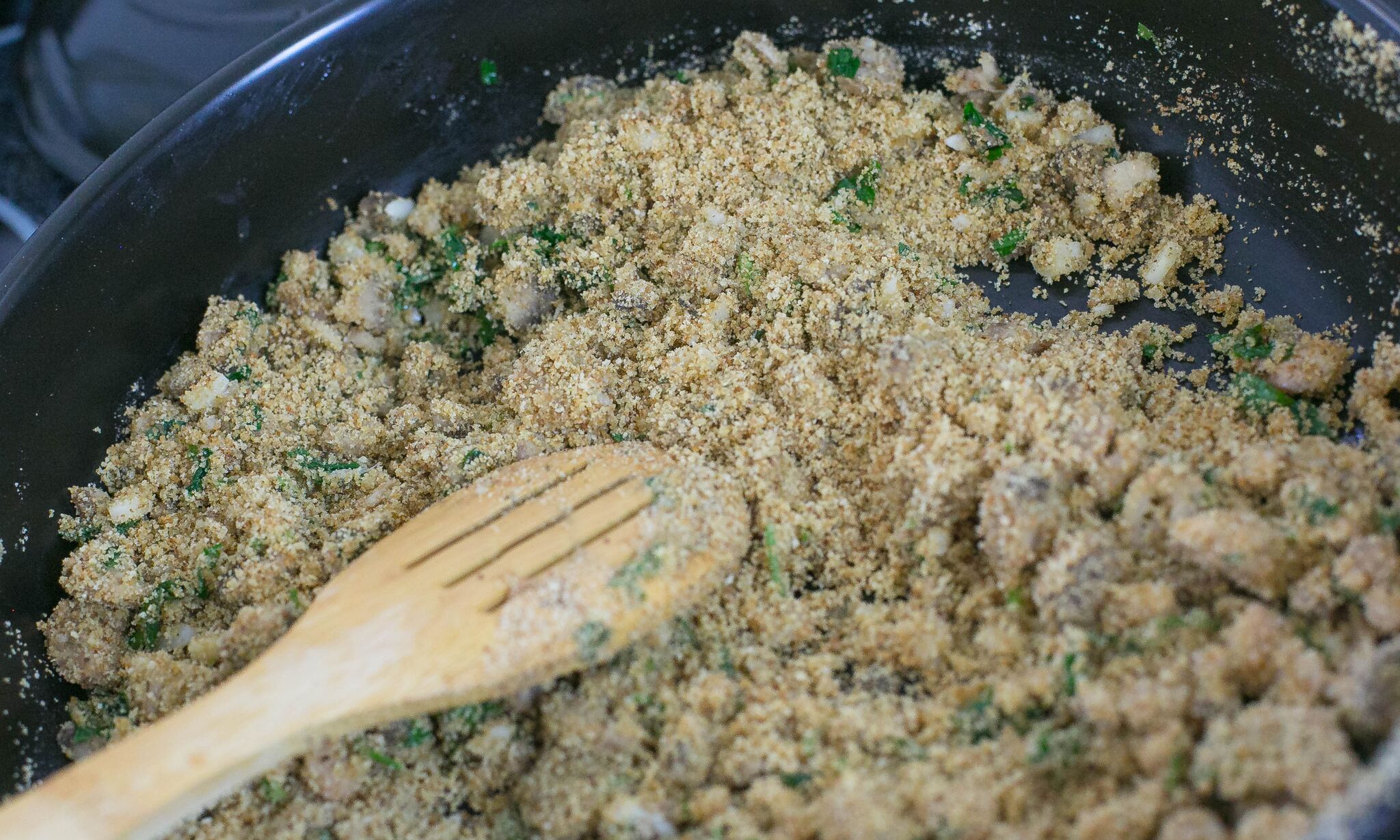 Add olive oil and bread crumbs to mushroom mixture and cook until lightly browned.