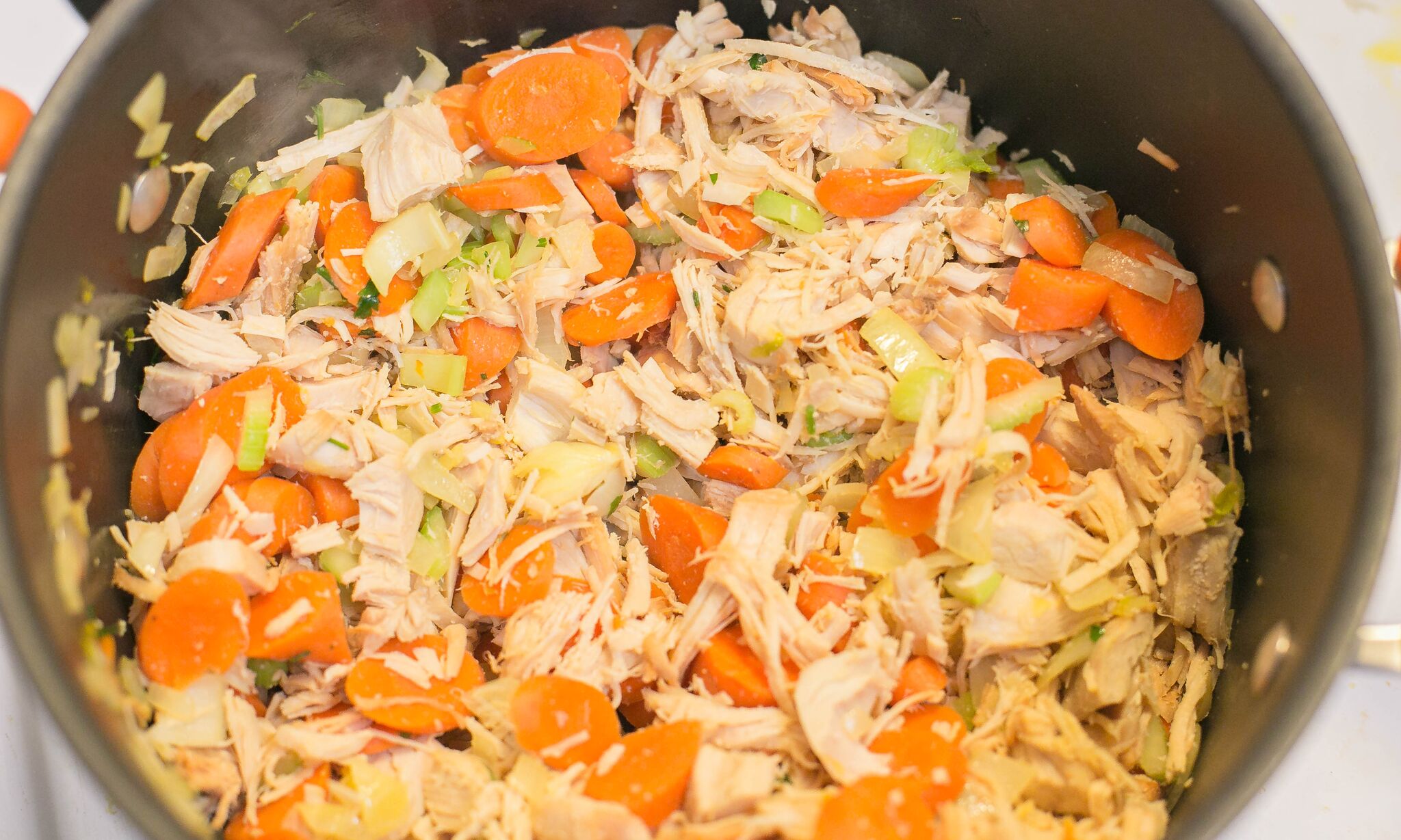 Turkey & Rice Soup | Add shredded turkey into the pot with the vegetables and stir. Season with salt and pepper. 