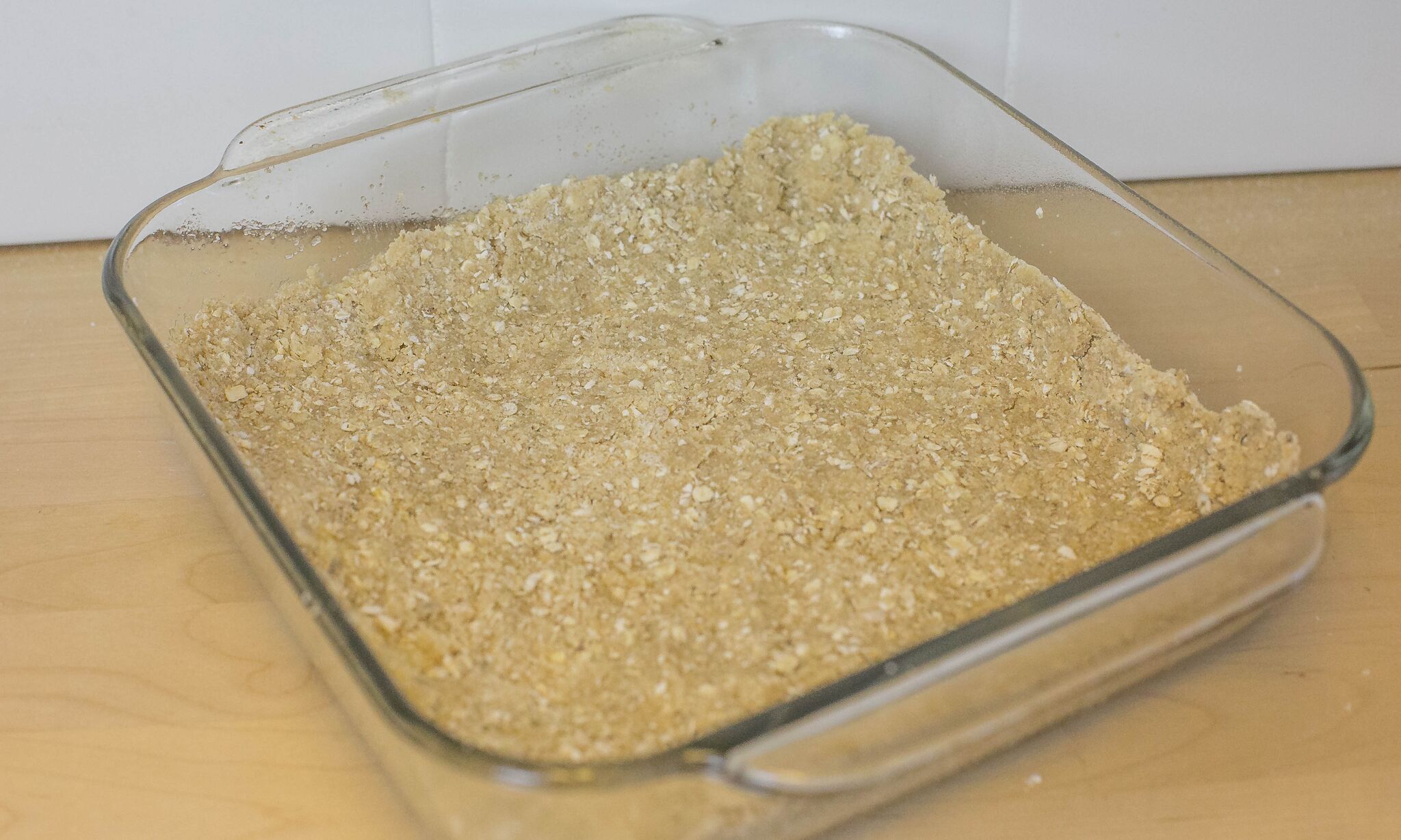 Press the remaining cookie mixture into the bottom of the baking dish.