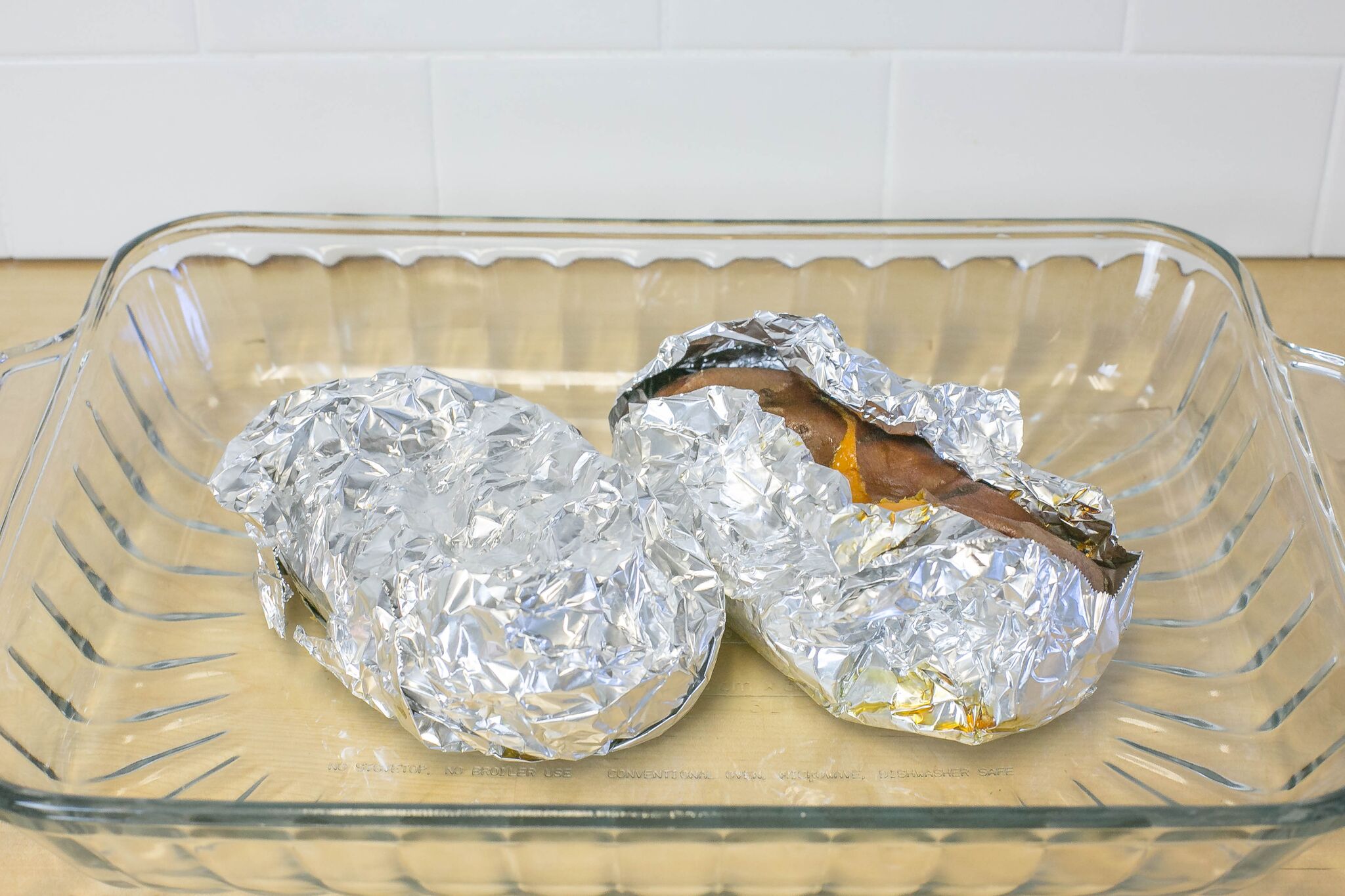 Pierce each sweet potato several times with a fork then wrap potatoes in foil and place in cooking sheet.