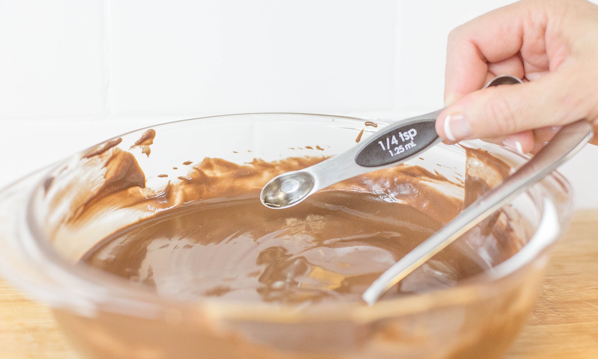 Add peppermint extract to melted chocolate mixture in bowl. 