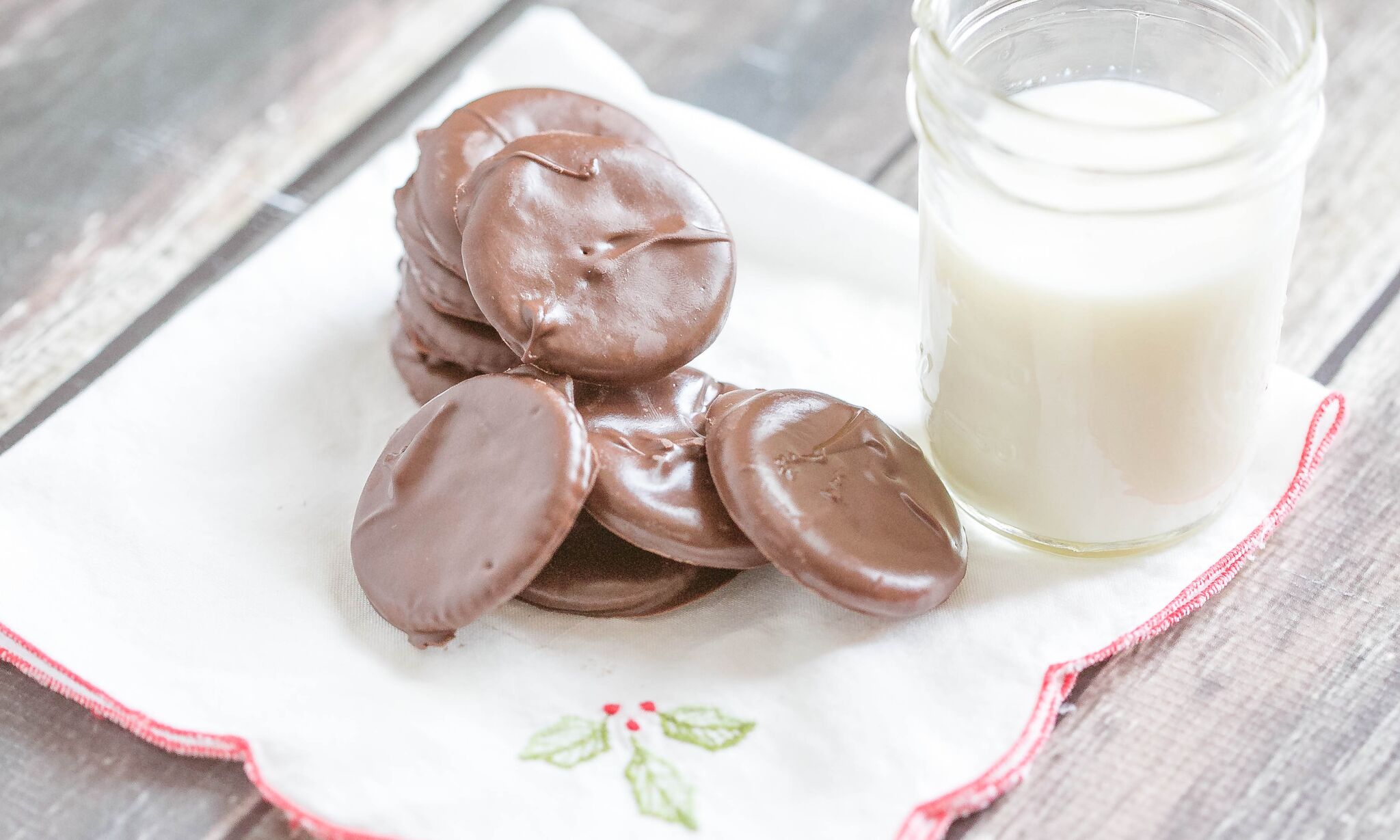 Serve chocolate mint cookies on a napkin with a glass of milk. 