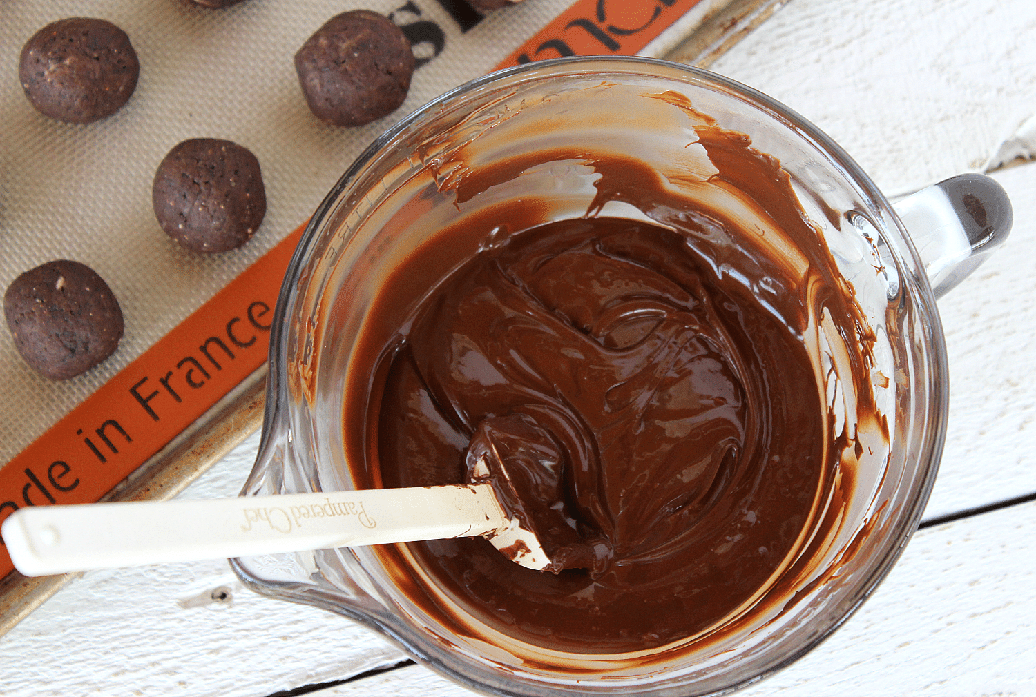 Freeze truffles then prepare to dip into melted chocolate mixture.