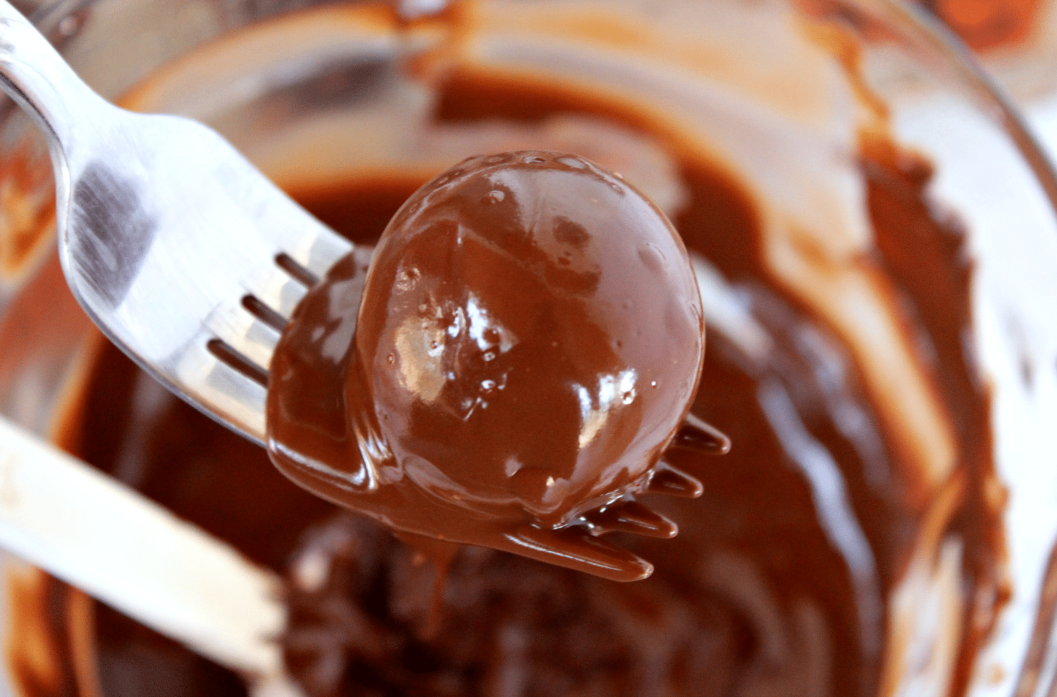 Using a fork, dip each frozen truffle one by one into melted chocolate. 