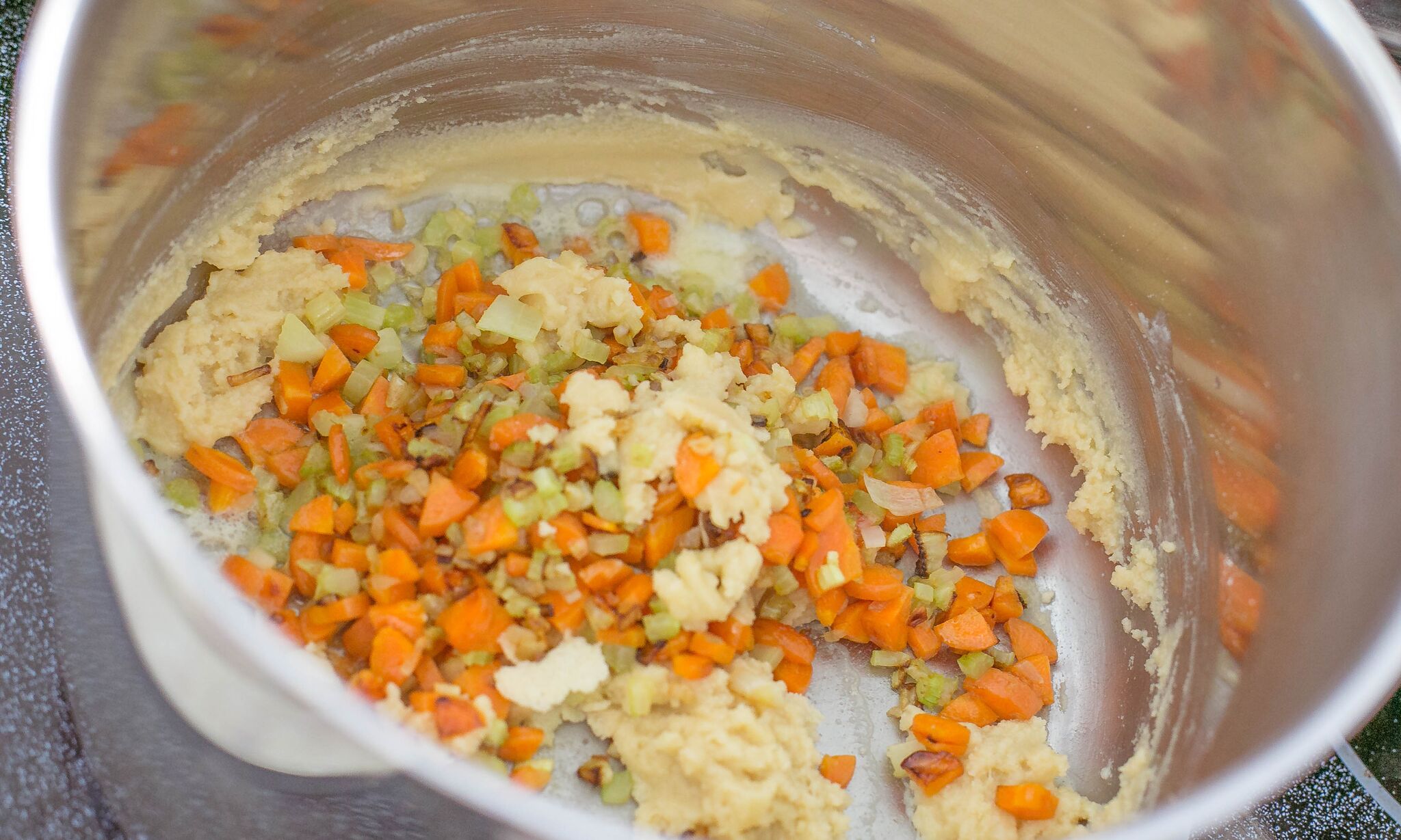 In large pot, add flour to butter and vegetables. 