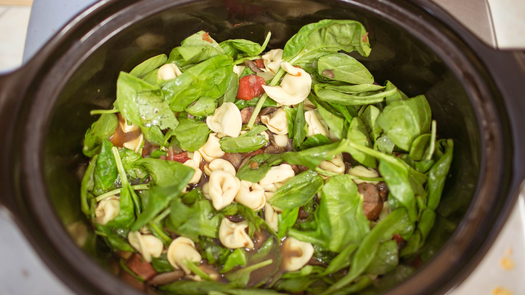 Once you are ready to eat; add package of tortellini directly into crock pot with fresh spinach and stir. 