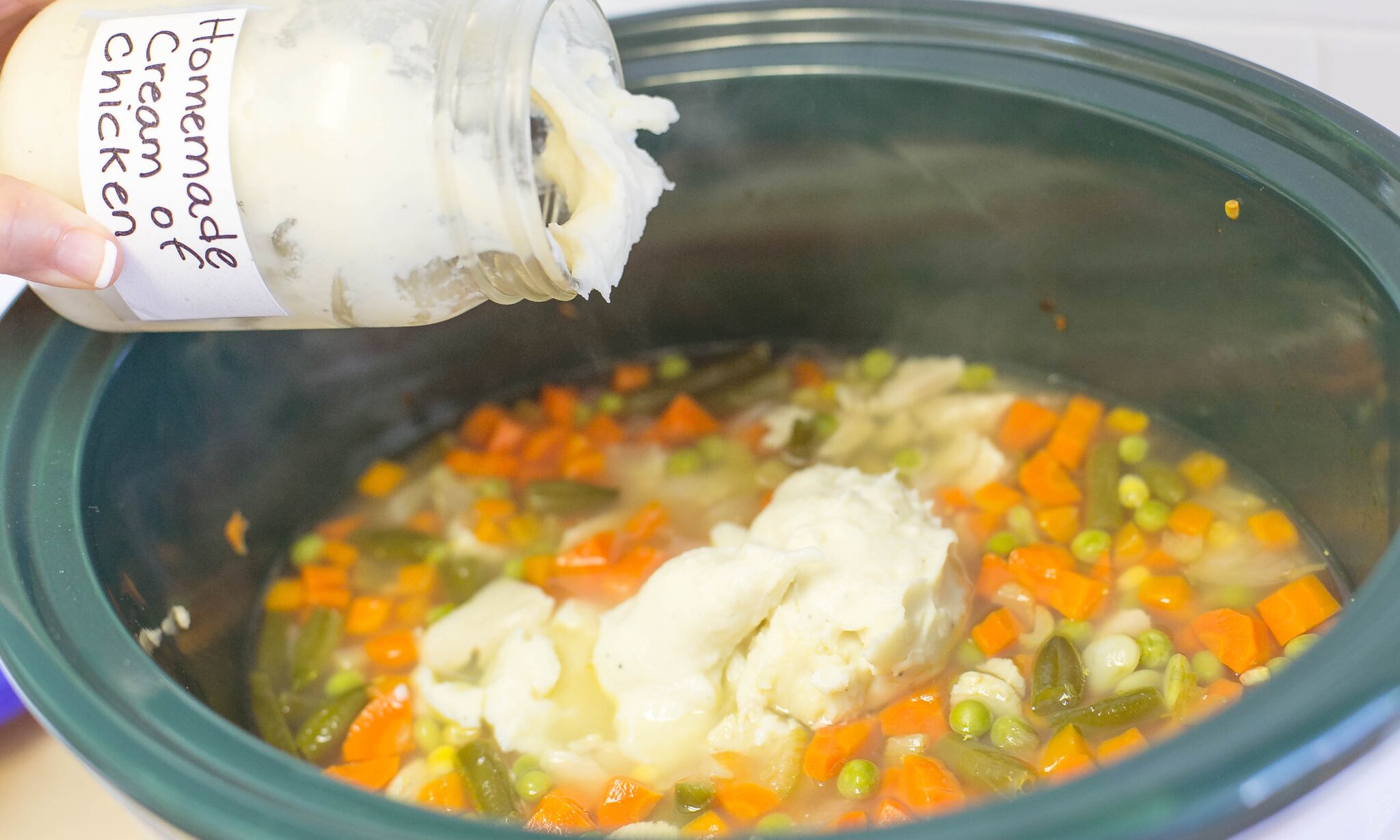 Add container of homemade cream of chicken soup to mixture in crockpot 