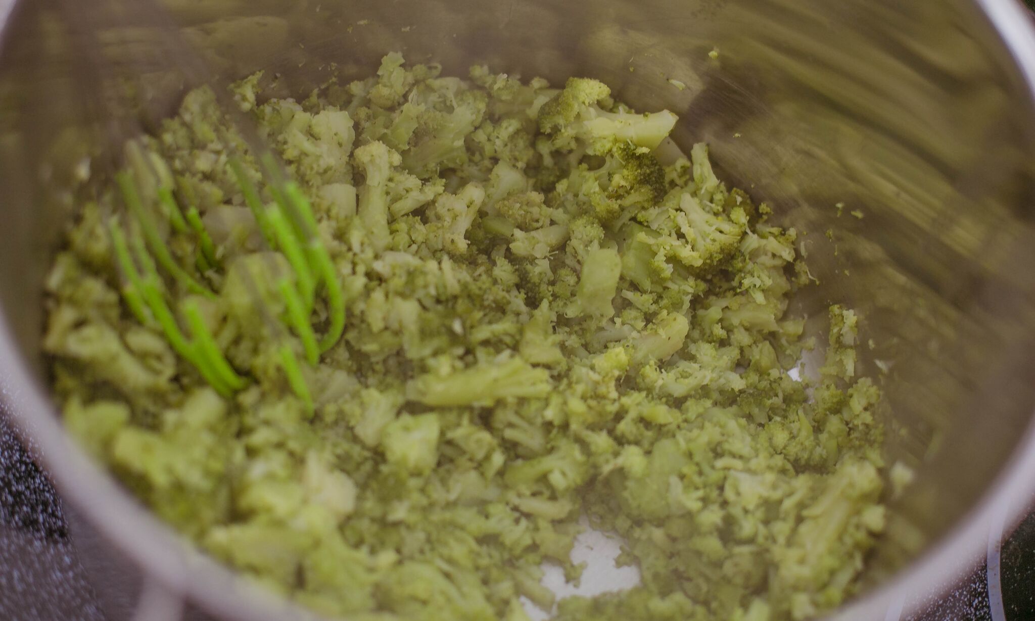 Steam broccoli first, then mash with a potato masher when cooled. 