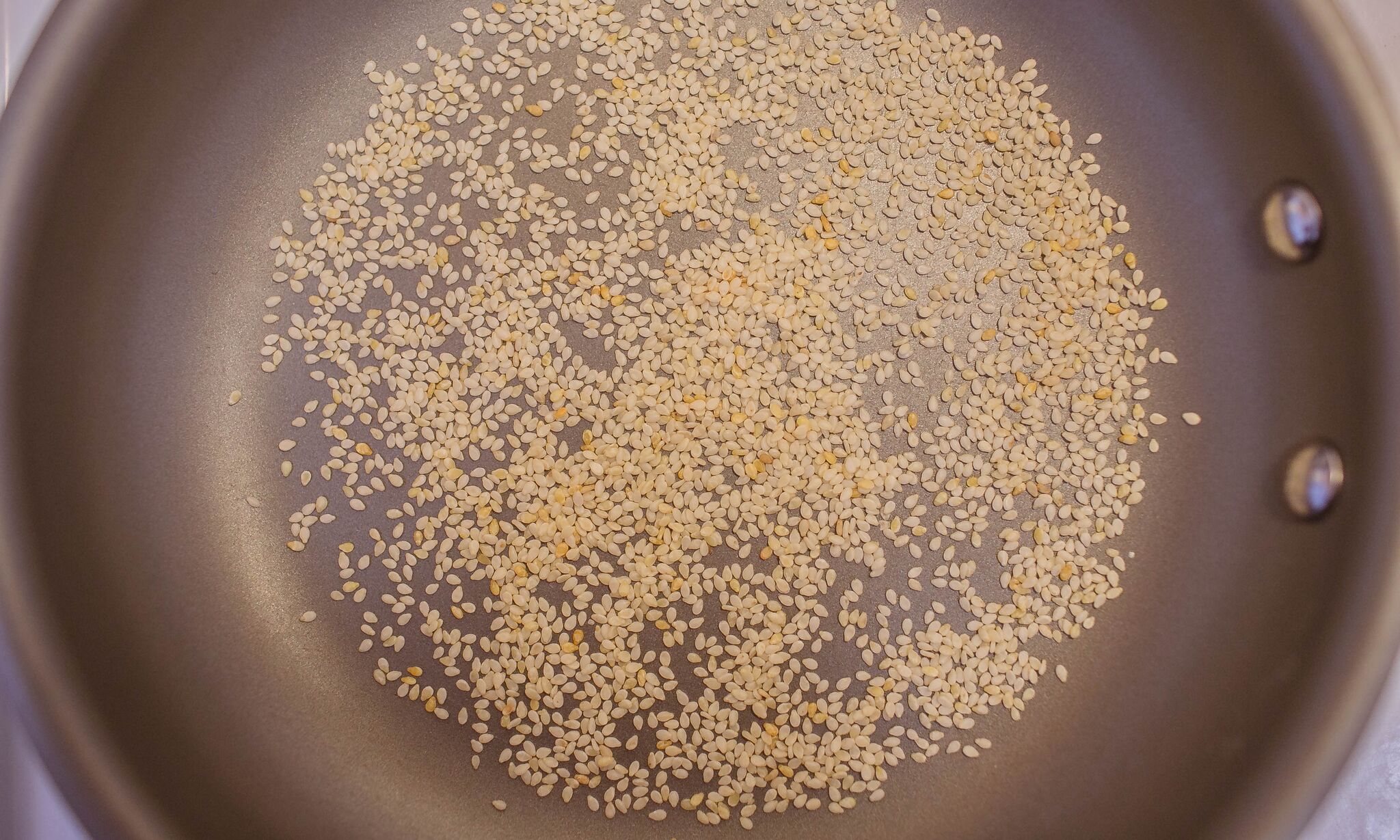 Toast sesame seeds in small frying pan until lightly golden in color.