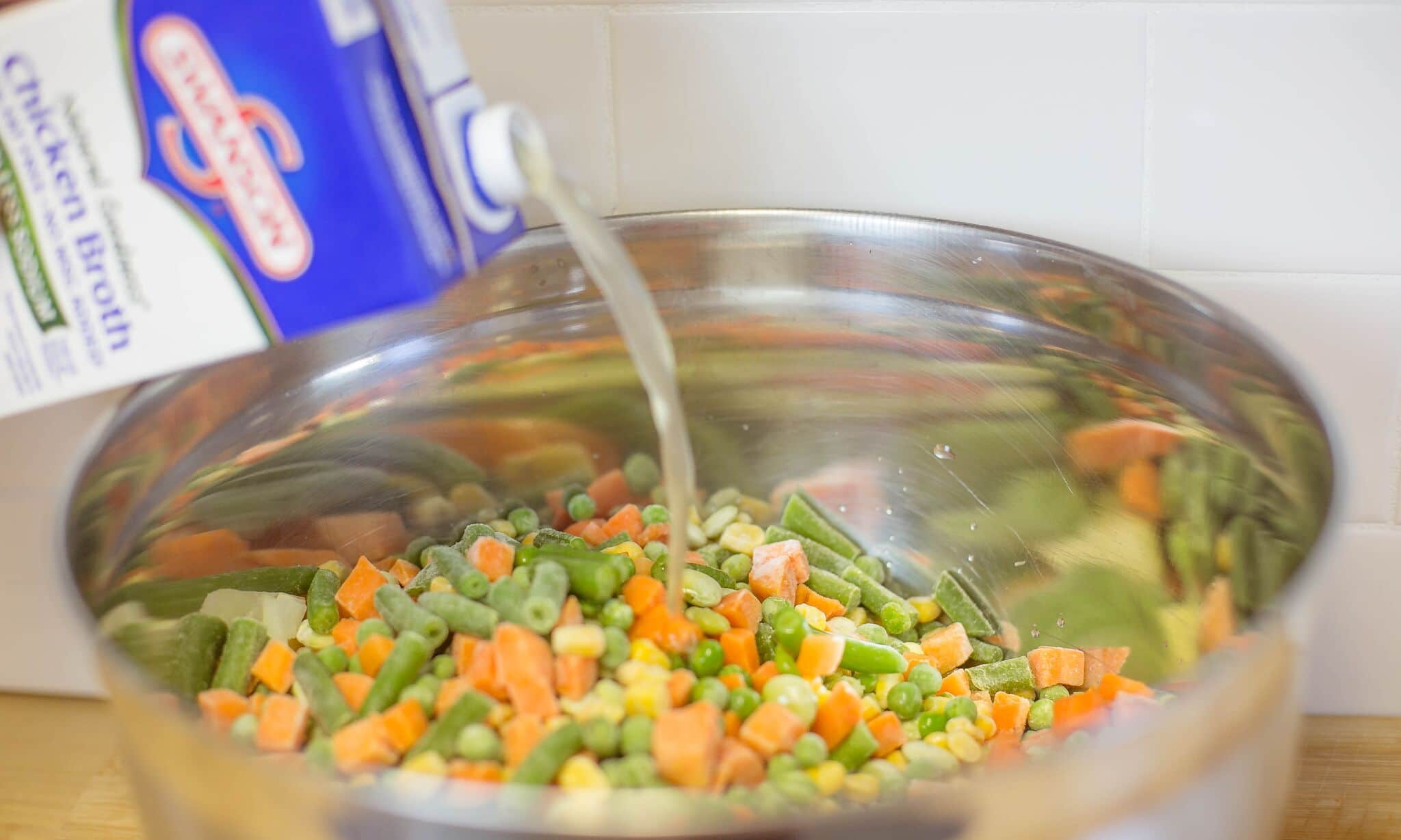 In a large bowl mix together onions, carrots, celery and mixed veggies then add chicken stock, slat and pepper