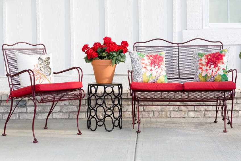 Colorful and floral outside patio furniture decorated with red accents. 