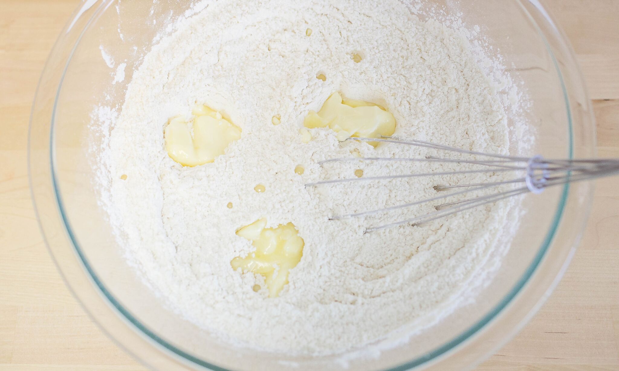 Whisk in some softened butter to the dry ingredients. 