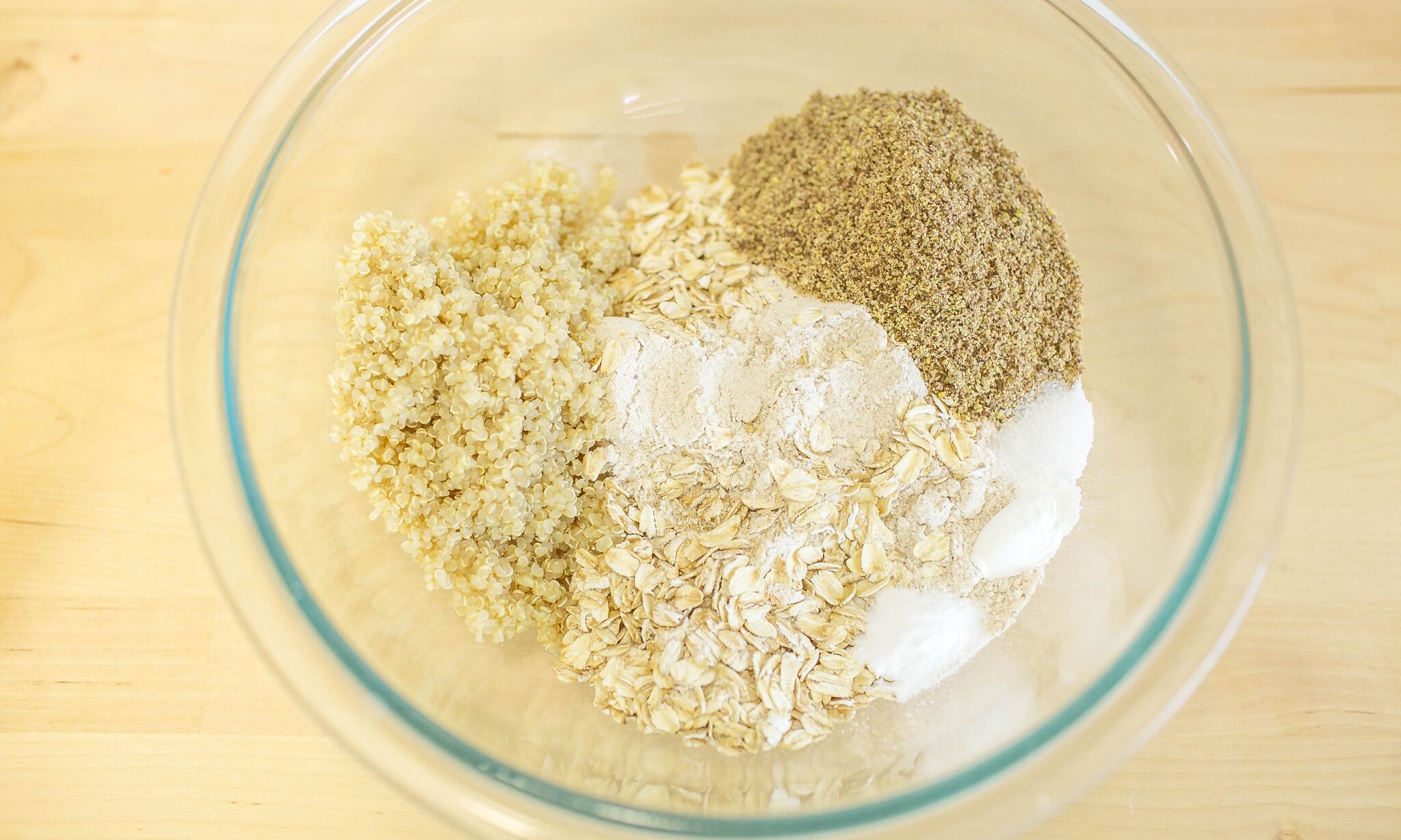 In a medium bowl mix together flour, oats, quinoa, flax seed meal, baking powder, baking soda and&nbsp;salt .