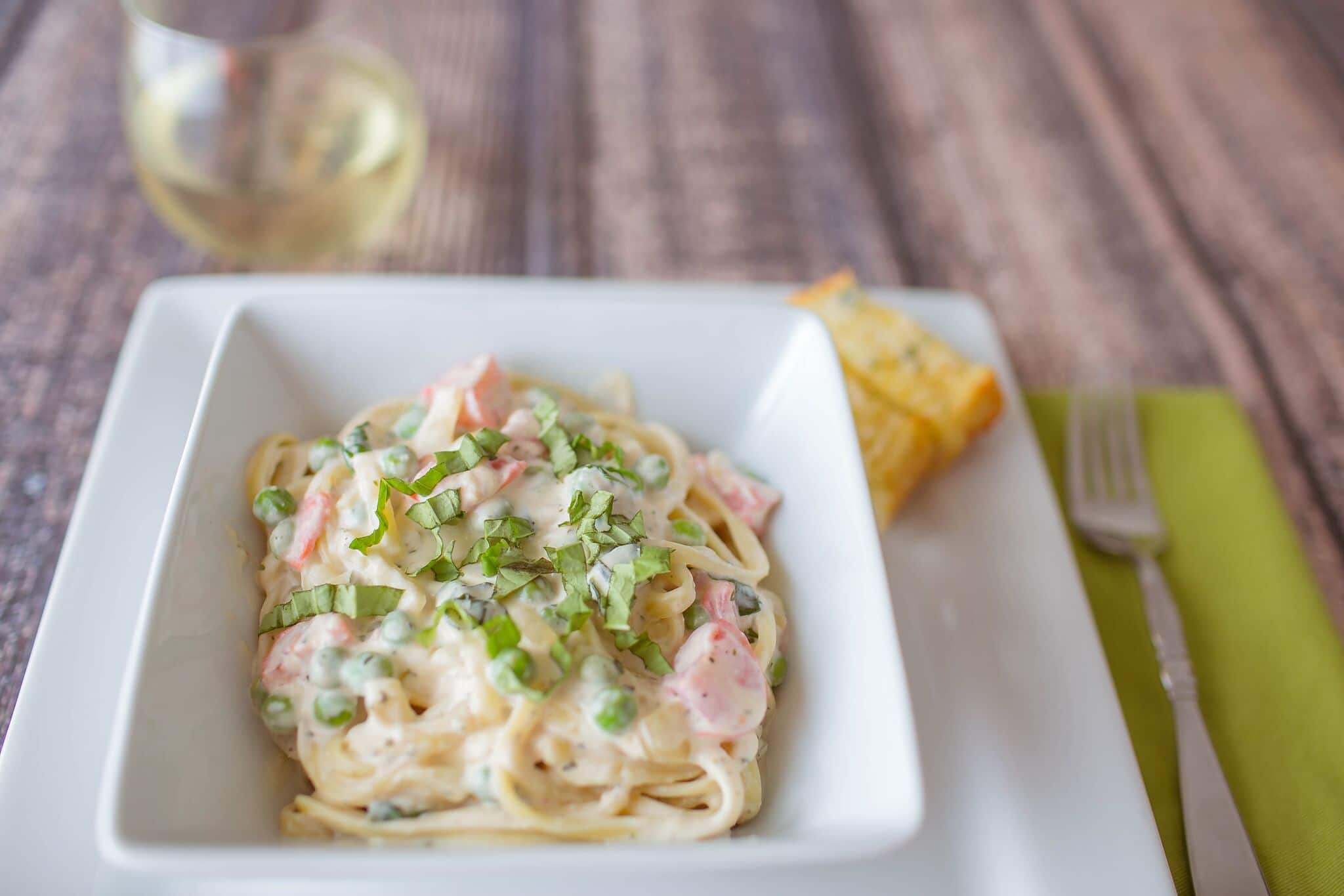 Spoon pasta into bowls and serve with fresh basil on top to garnish. 