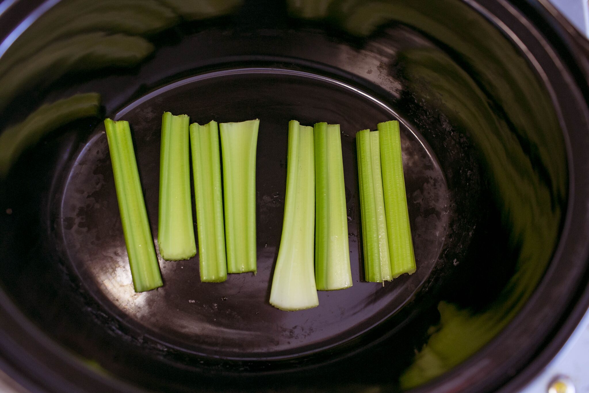 Wash celery and place in slow cooker. 