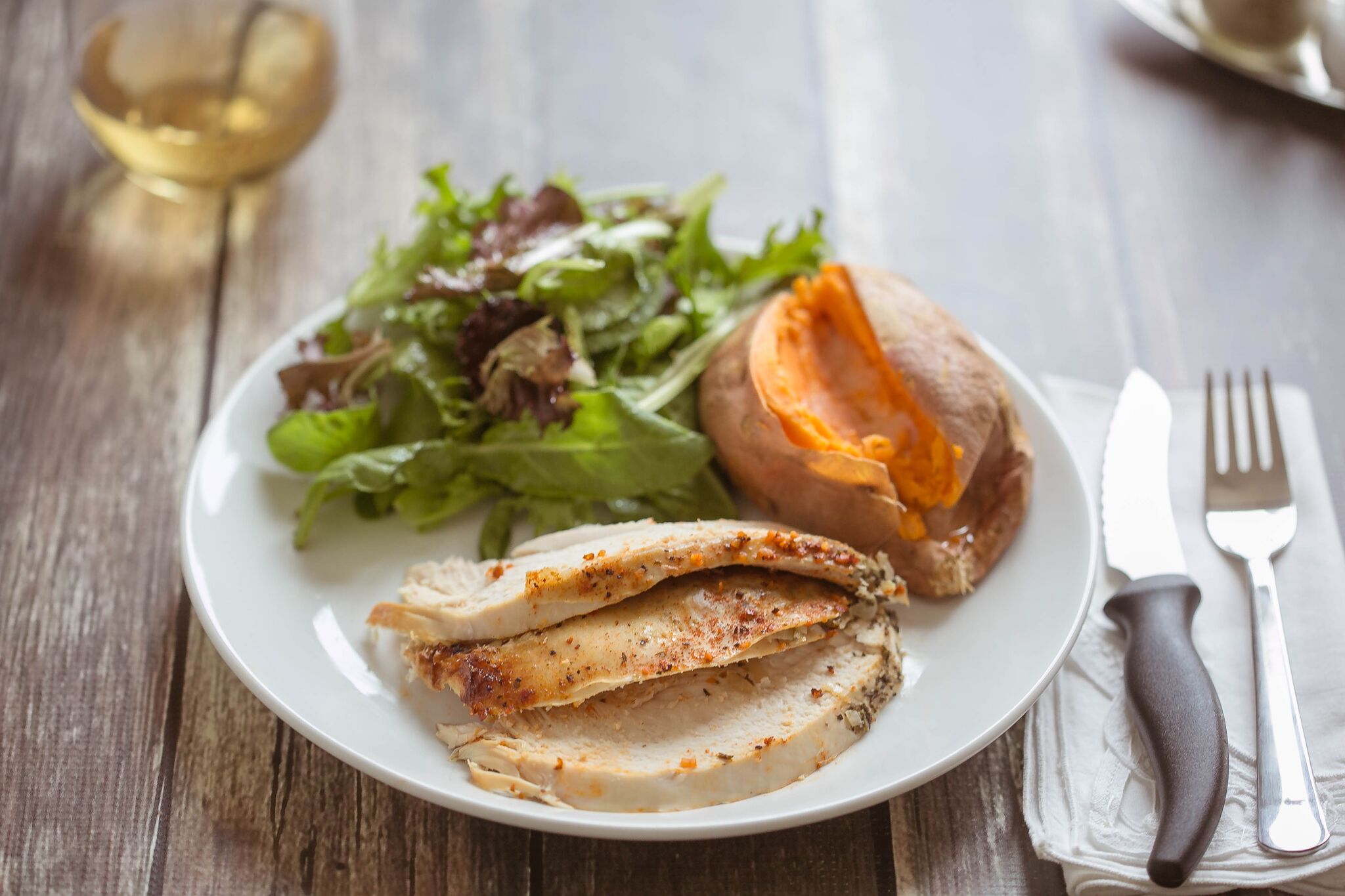 Serve finished chicken with a salad, sweet potato, and a glass of wine then enjoy. 